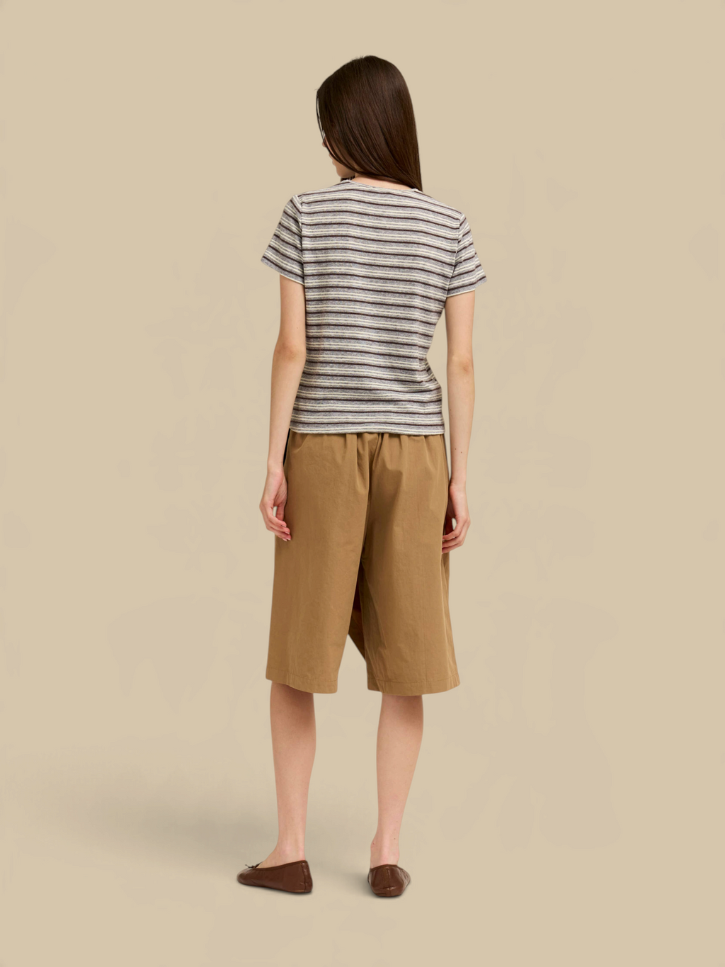 Homestyle Collective light grey striped jersey t-shirt with short sleeves worn with tan shorts, back view