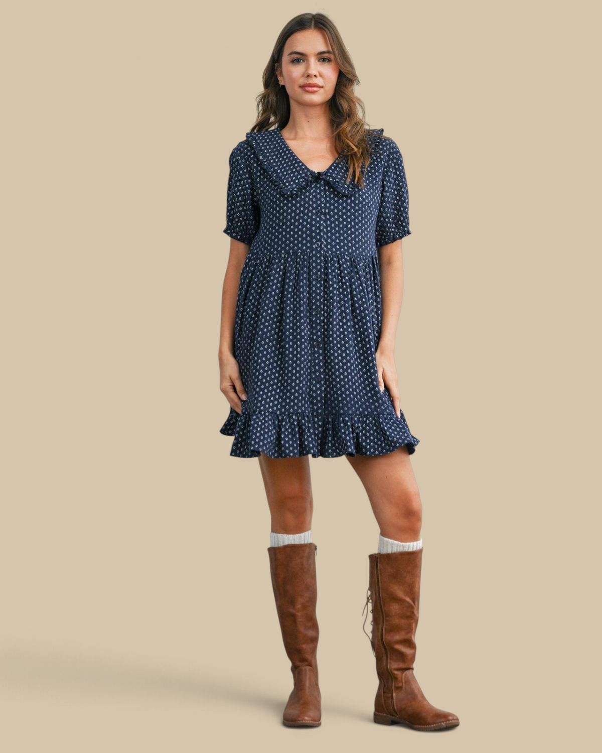 Homestyle Collective navy puff-sleeve mini dress with a ruffled hem, collar, and button front, worn with brown boots.