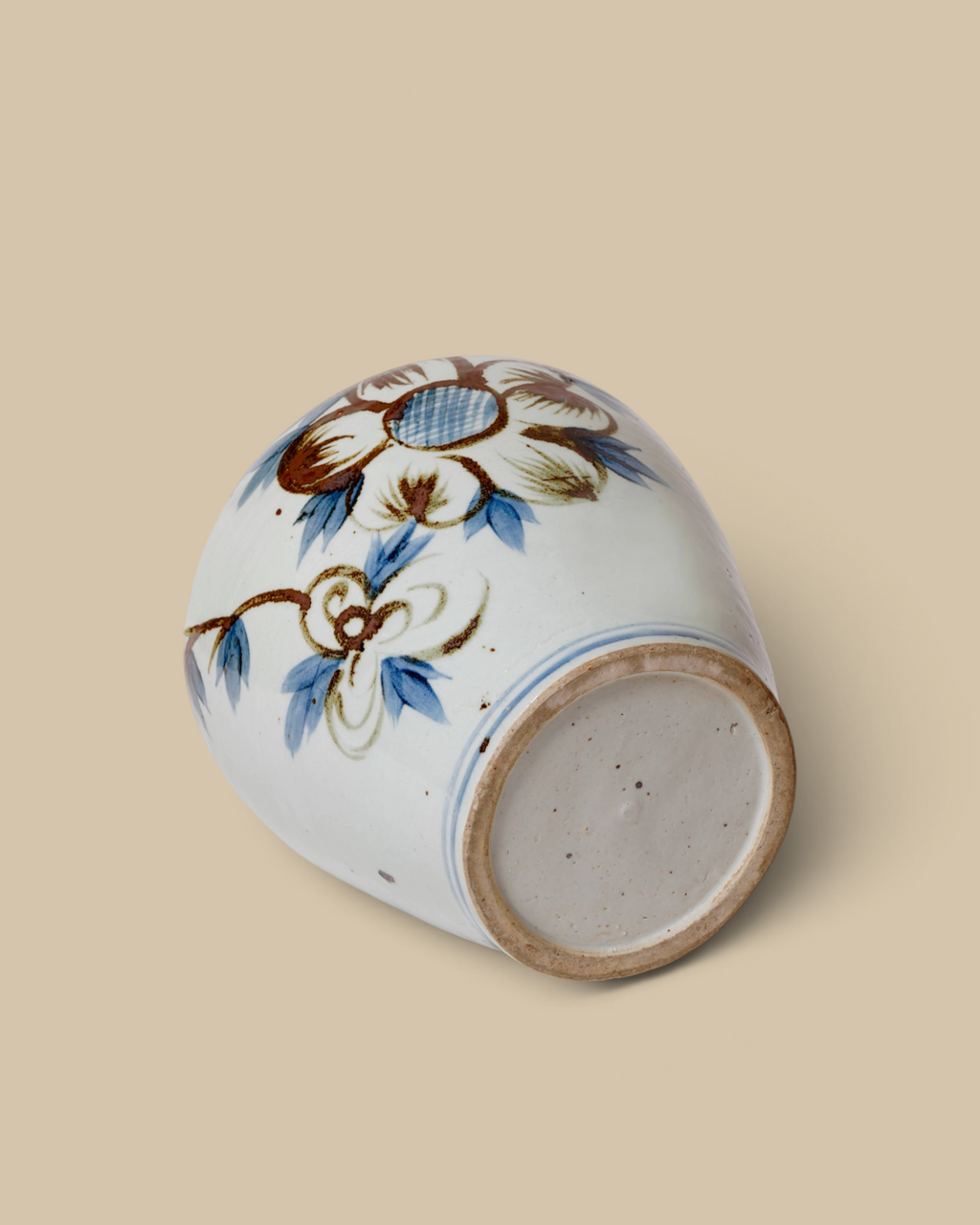 Homestyle Collective hand-painted porcelain vase featuring brown and blue sunflower motifs on a white background.