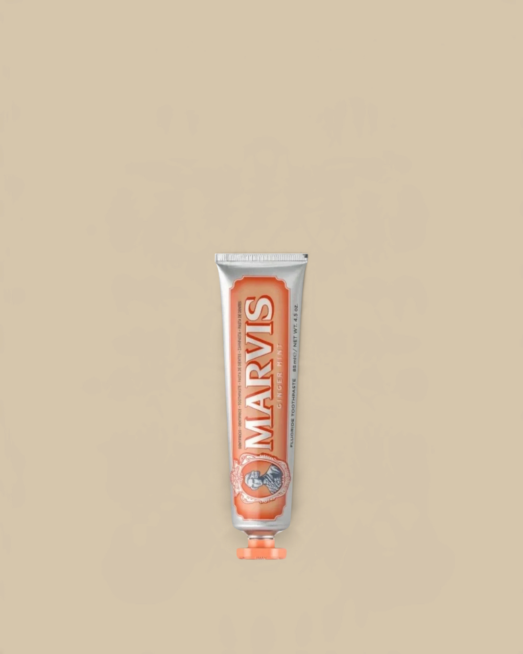 Homestyle Collective Marvis Ginger Mint toothpaste in a travel-sized silver tube with orange accents.