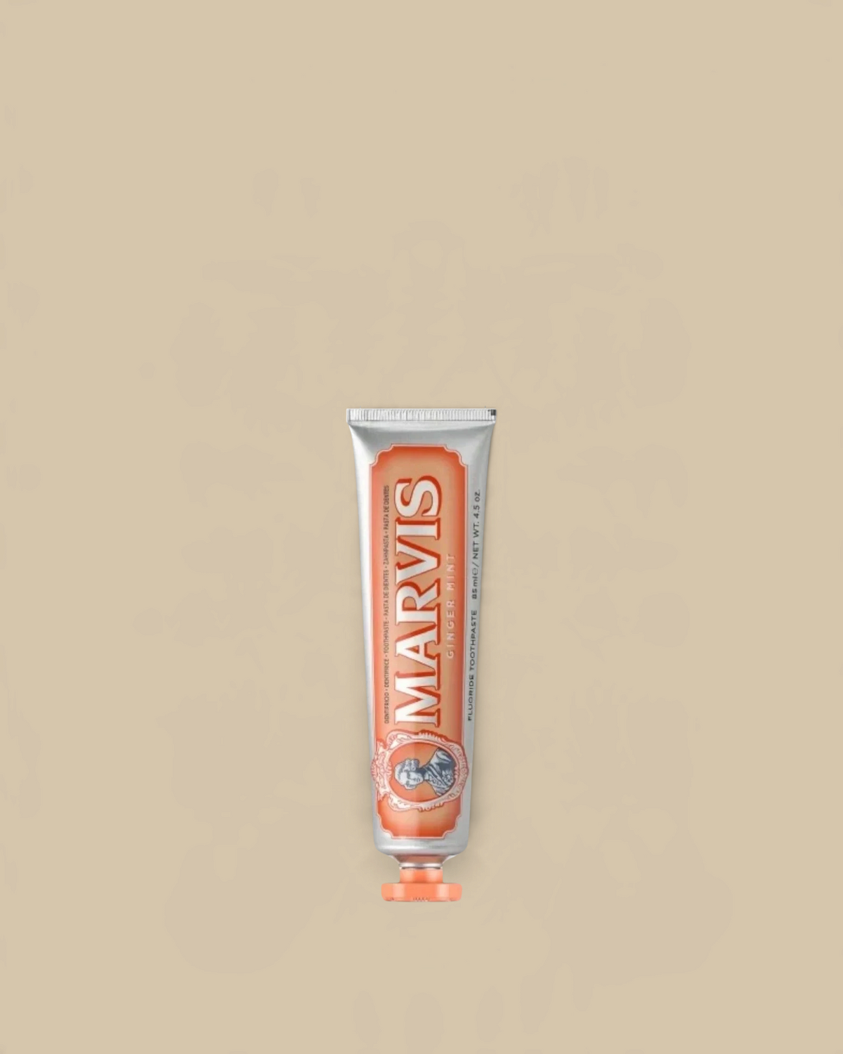 Homestyle Collective Marvis Ginger Mint toothpaste in a travel-sized silver tube with orange accents.