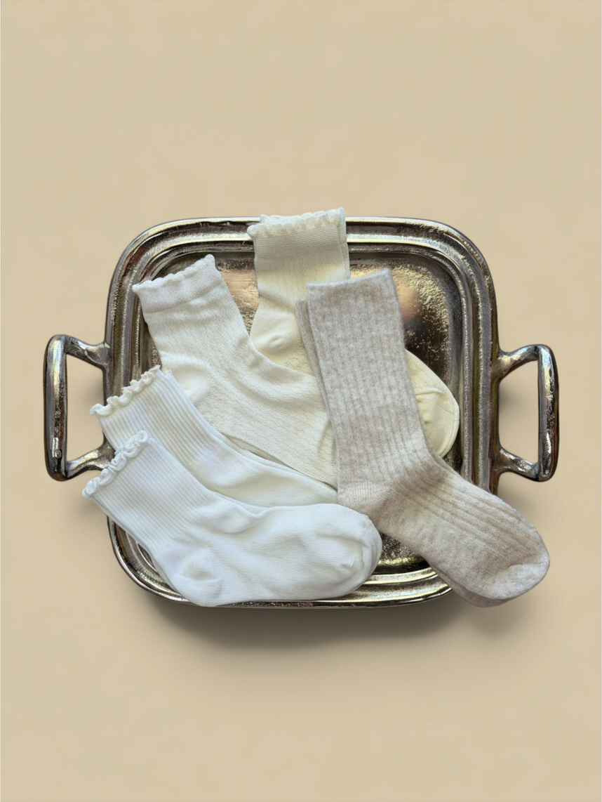 Homestyle Collective plush wool crew socks in apricot and cream shades with ribbed texture and ruffled cuffs.