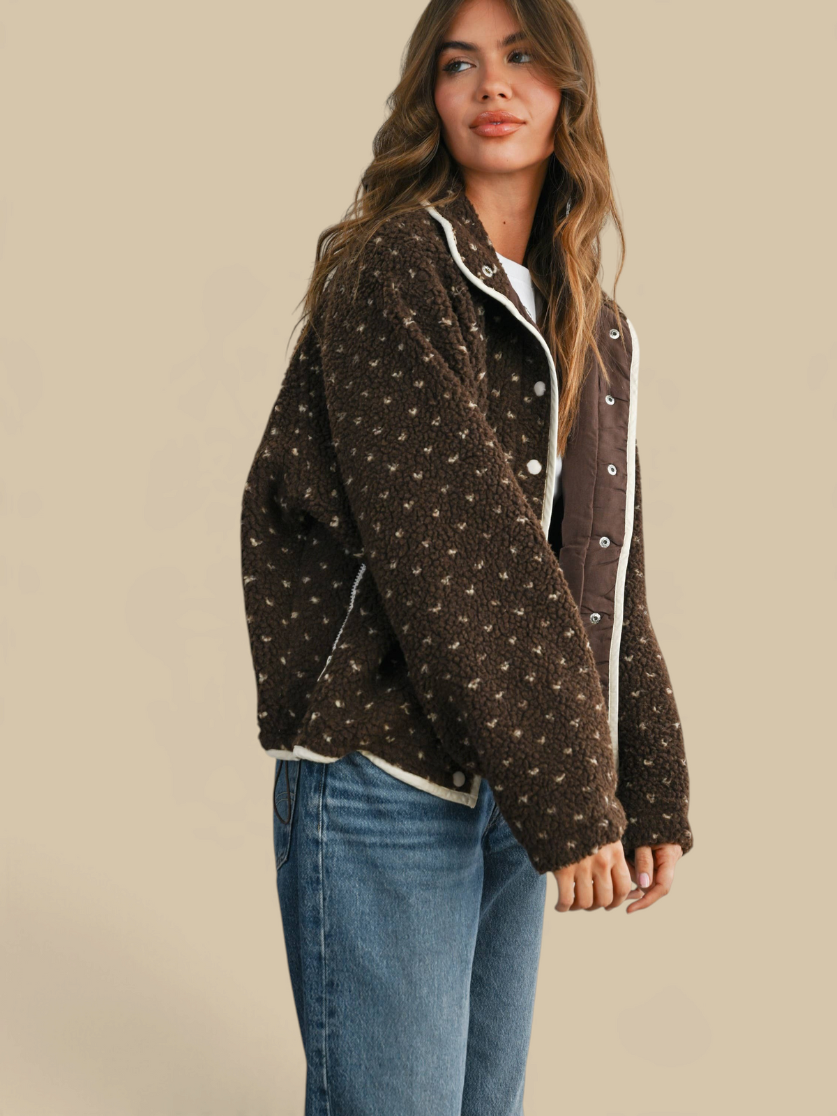 Model wearing a Homestyle Collective brown high pile fleece puffer jacket with quilted details and white trim.