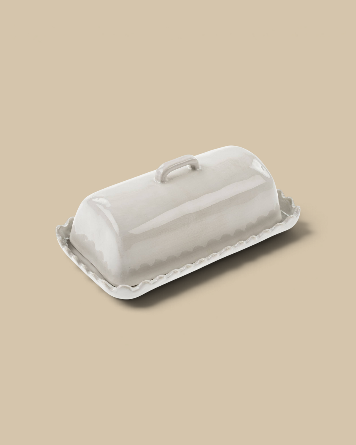 Homestyle Collective handcrafted stoneware butter dish with a glossy neutral glaze and decorative scalloped edges.