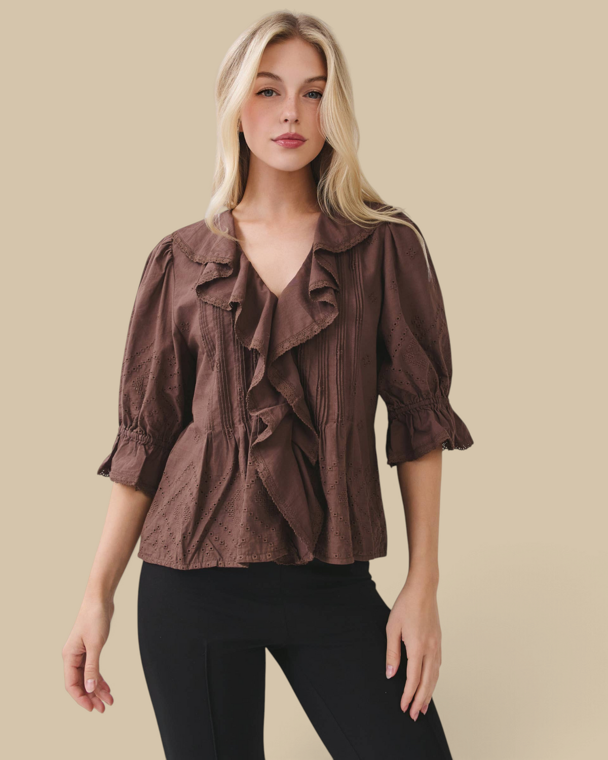 Homestyle Collective brown cotton eyelet blouse with ruffle front, pintuck pleating, and volume sleeves on a model.