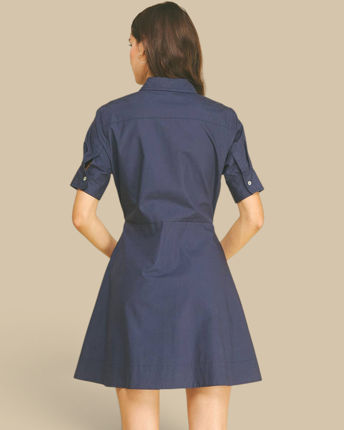 Back view of a Homestyle Collective navy mini dress with short sleeves, button cuffs, and a classic collar.
