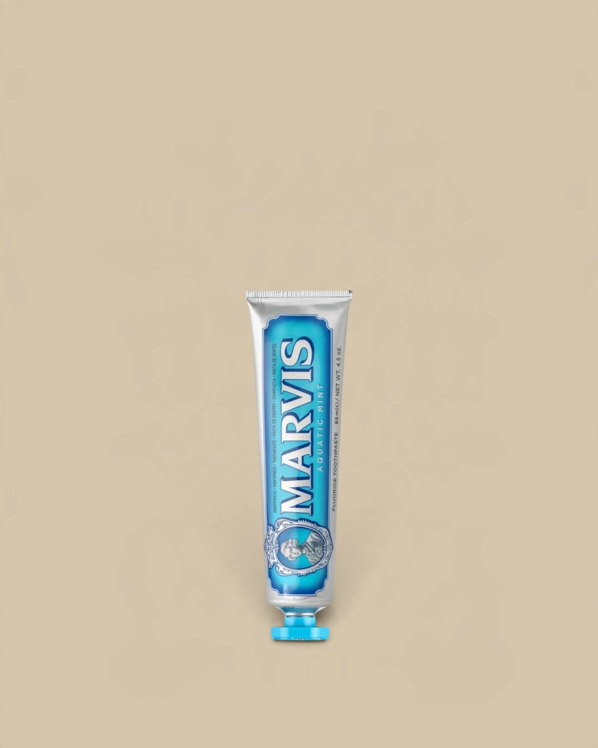 Homestyle Collective Marvis Aquatic Mint toothpaste in a silver travel-size tube with blue accents.