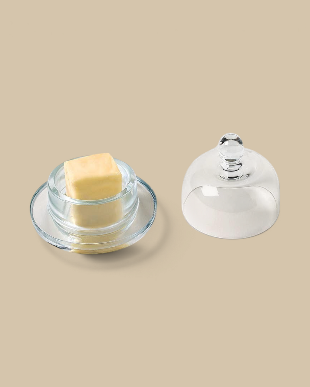 Homestyle Collective small clear glass butter dish with a matching domed lid and a block of butter on the base