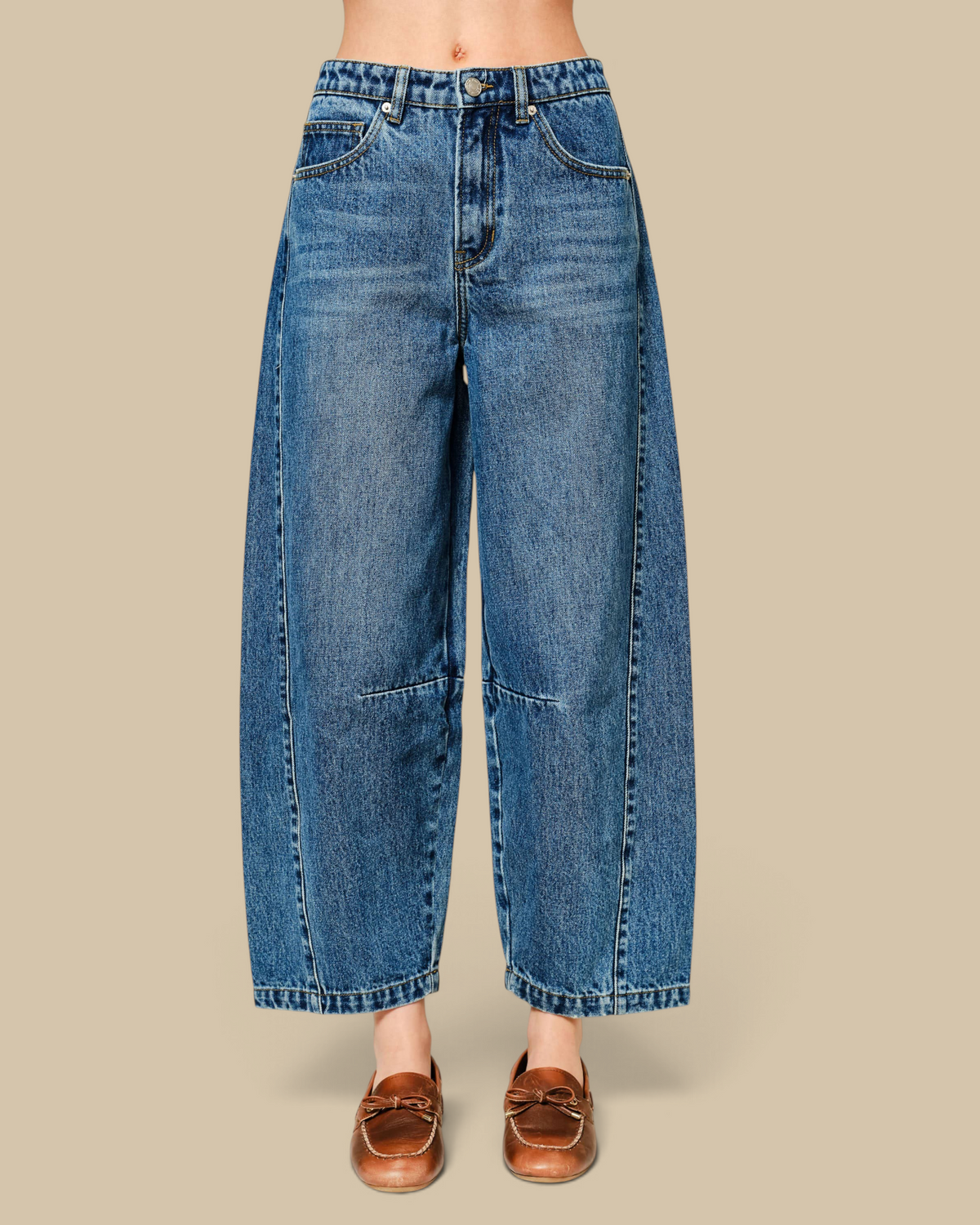Homestyle Collective mid-rise cropped barrel jeans in blue denim with seam detailing and a wide curved leg silhouette.