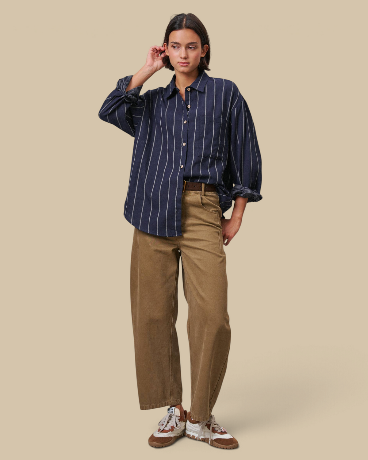 Homestyle Collective tan cotton barrel leg pants with a high-rise fit and cropped ankle worn with a striped shirt.