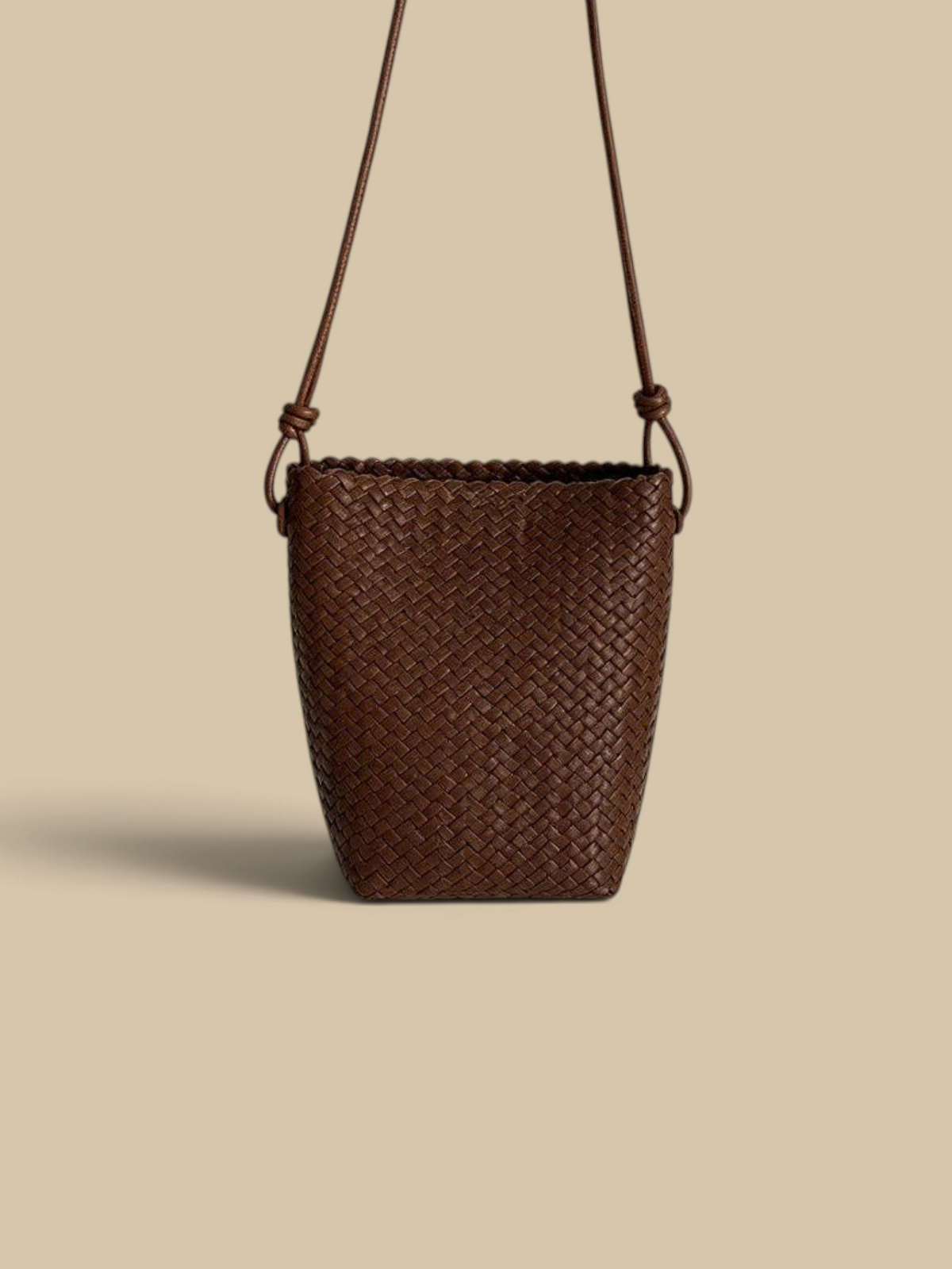 Homestyle Collective coffee brown woven faux leather tapered crossbody bag with a slim shoulder strap