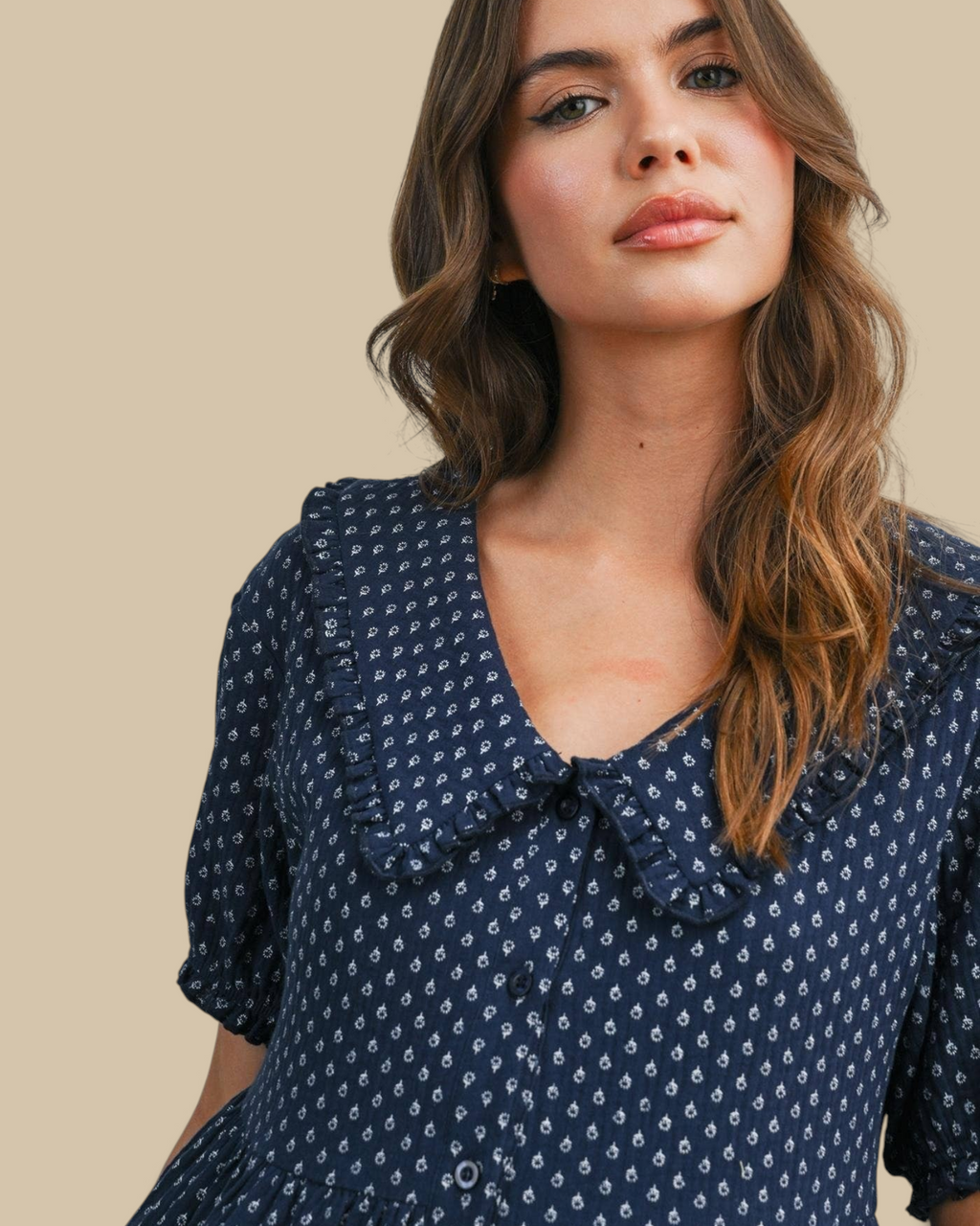 Homestyle Collective navy mini dress with puff sleeves, ruffled collar, and white floral print on a model