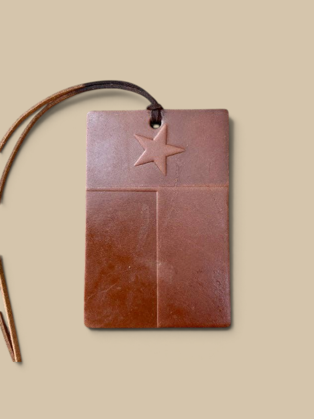 Homestyle Collective leather scented air freshener featuring a Texas flag design with a star on a brown leather tag.
