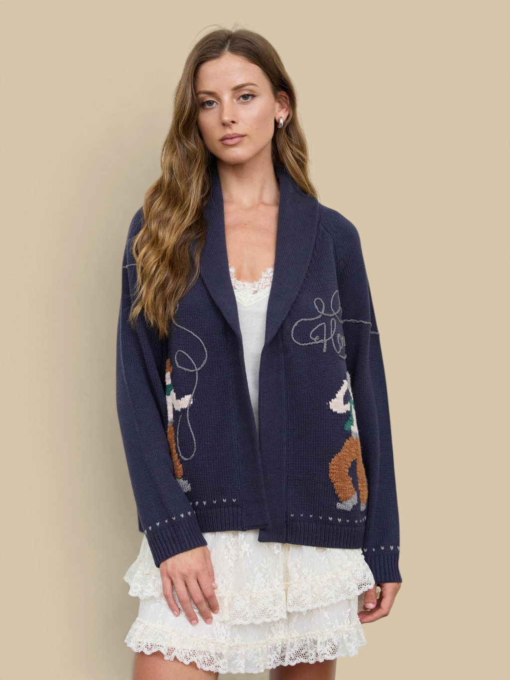 Model wearing a Homestyle Collective navy knit cardigan with a Howdy Cowboy jacquard pattern and shawl collar.