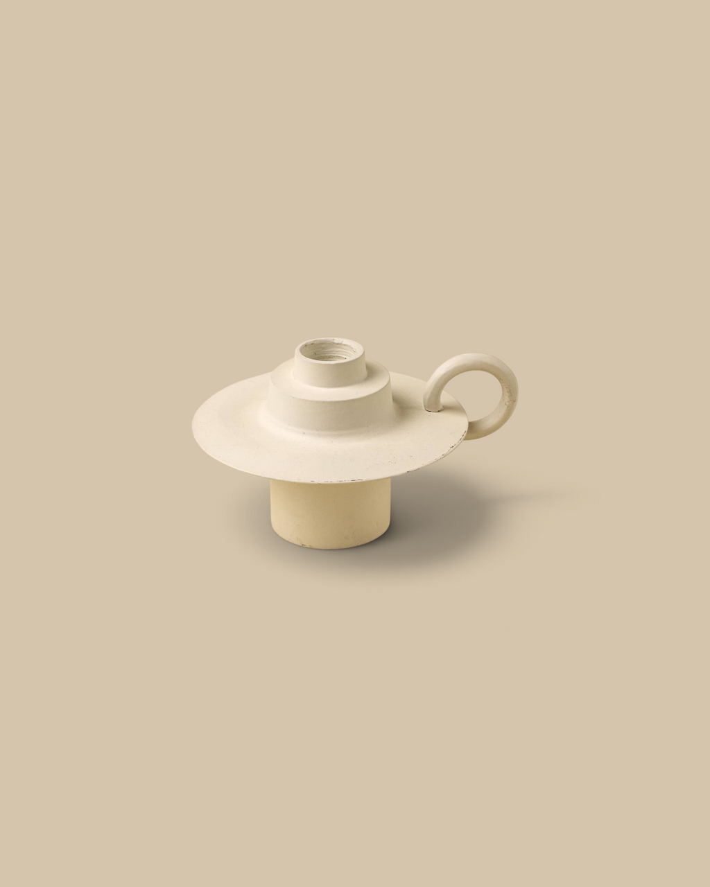 Homestyle Collective ivory aluminum Foundry candle holder with a looped handle and weathered patina finish.