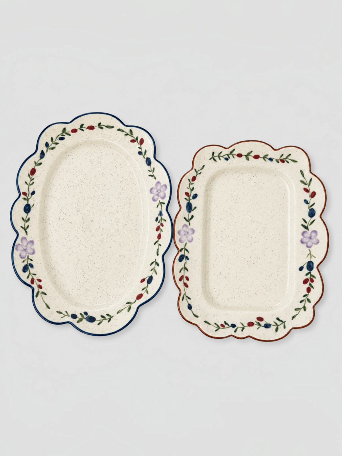 Homestyle Collective ceramic snack plates with scalloped edges and delicate floral patterns in oval and rectangular