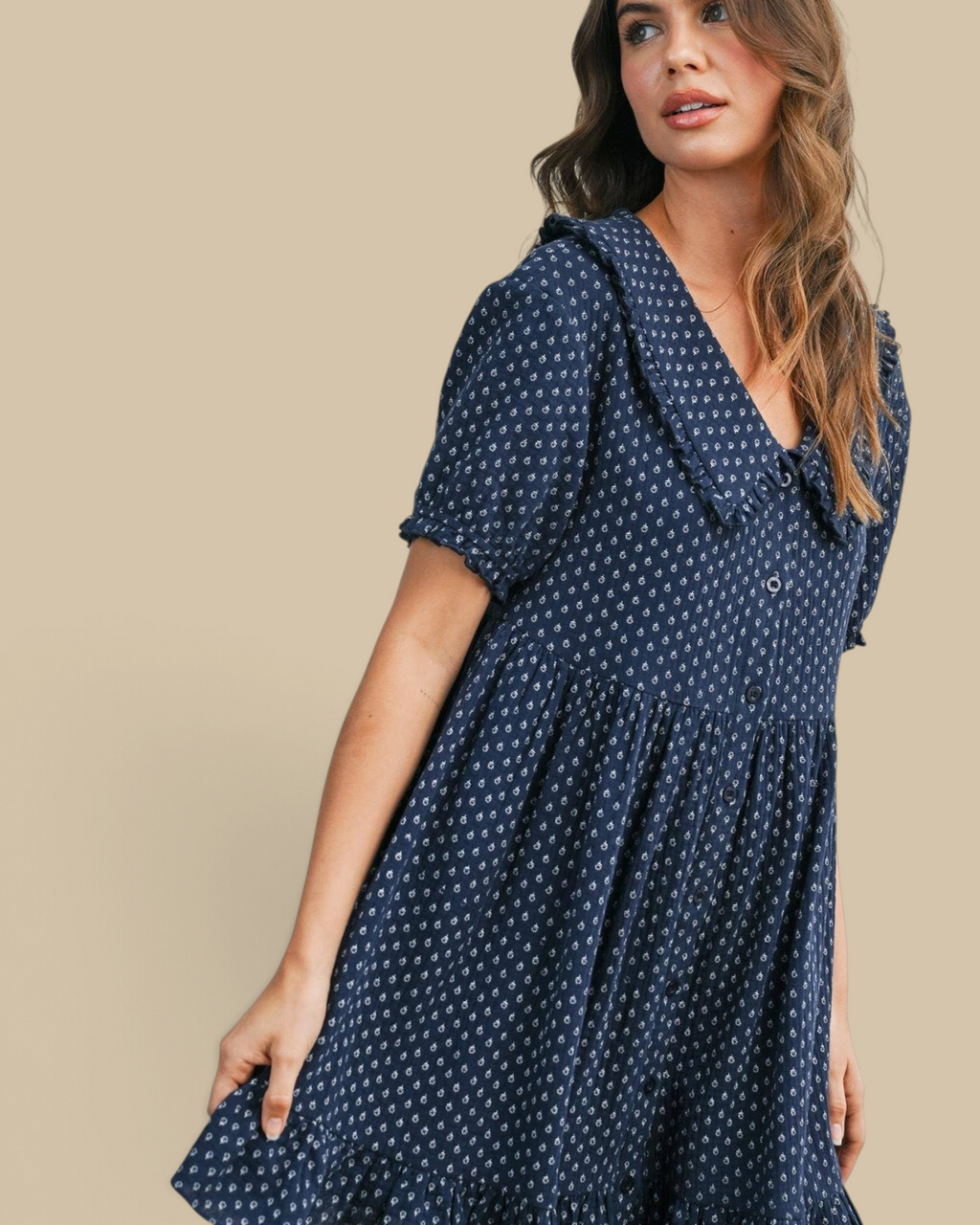 Homestyle Collective navy mini dress with puff sleeves, ruffled hem, and white floral print on a model
