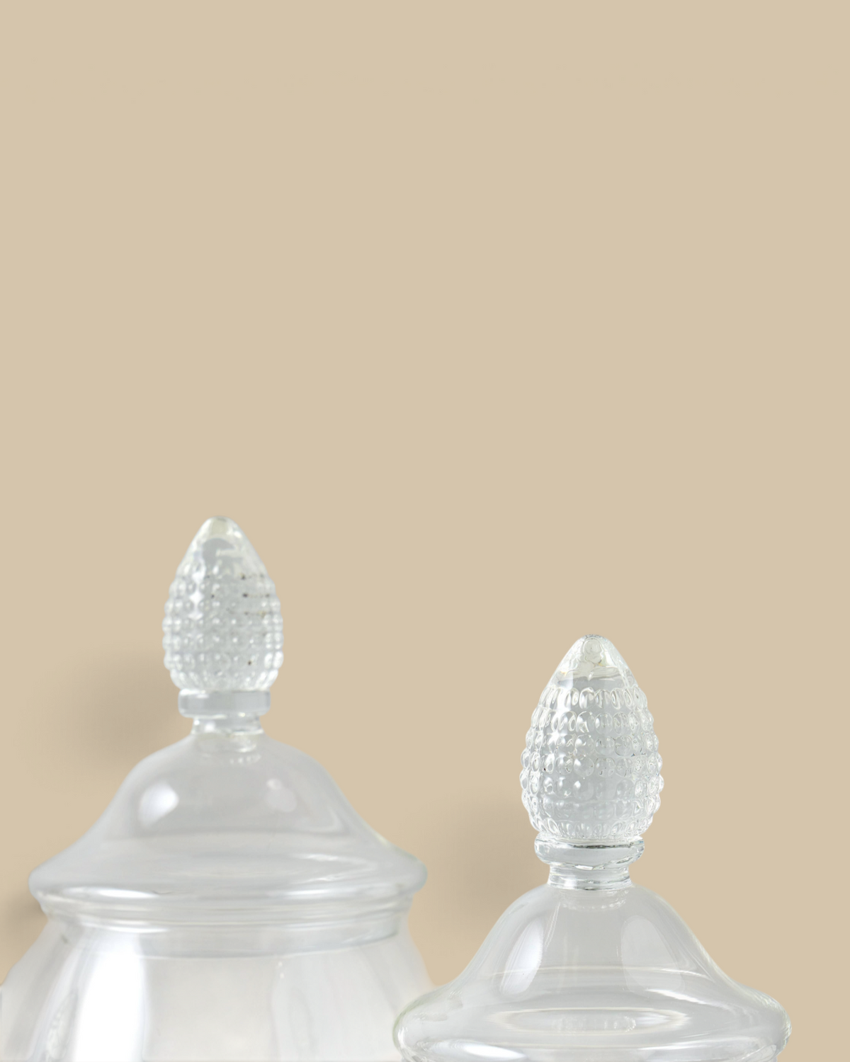 Homestyle Collective glass teardrop jars with textured finials for elegant kitchen storage and home decor.