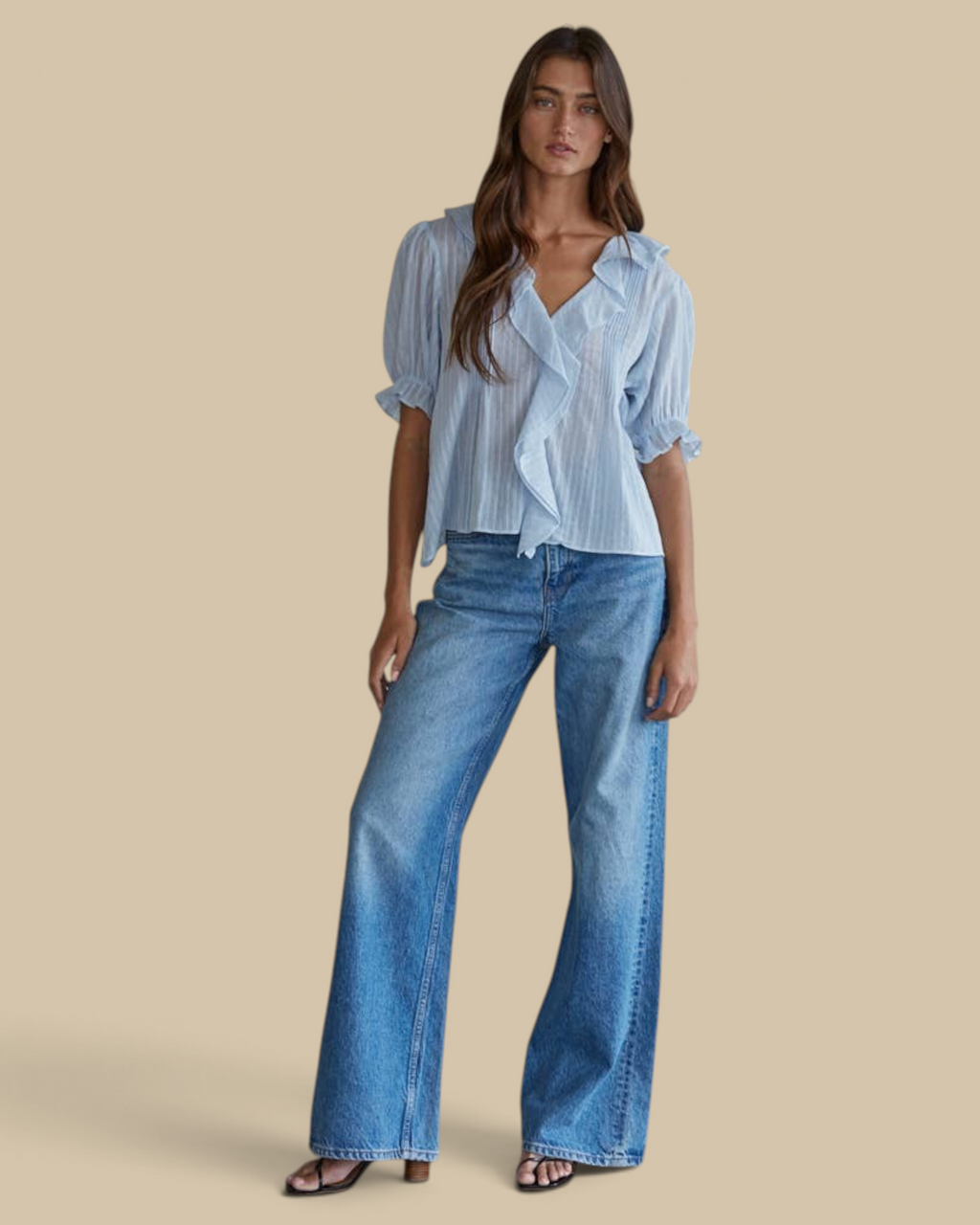 Homestyle Collective powder blue cotton blouse with ruffle trim, pintuck details, and V-neck worn with blue jeans.