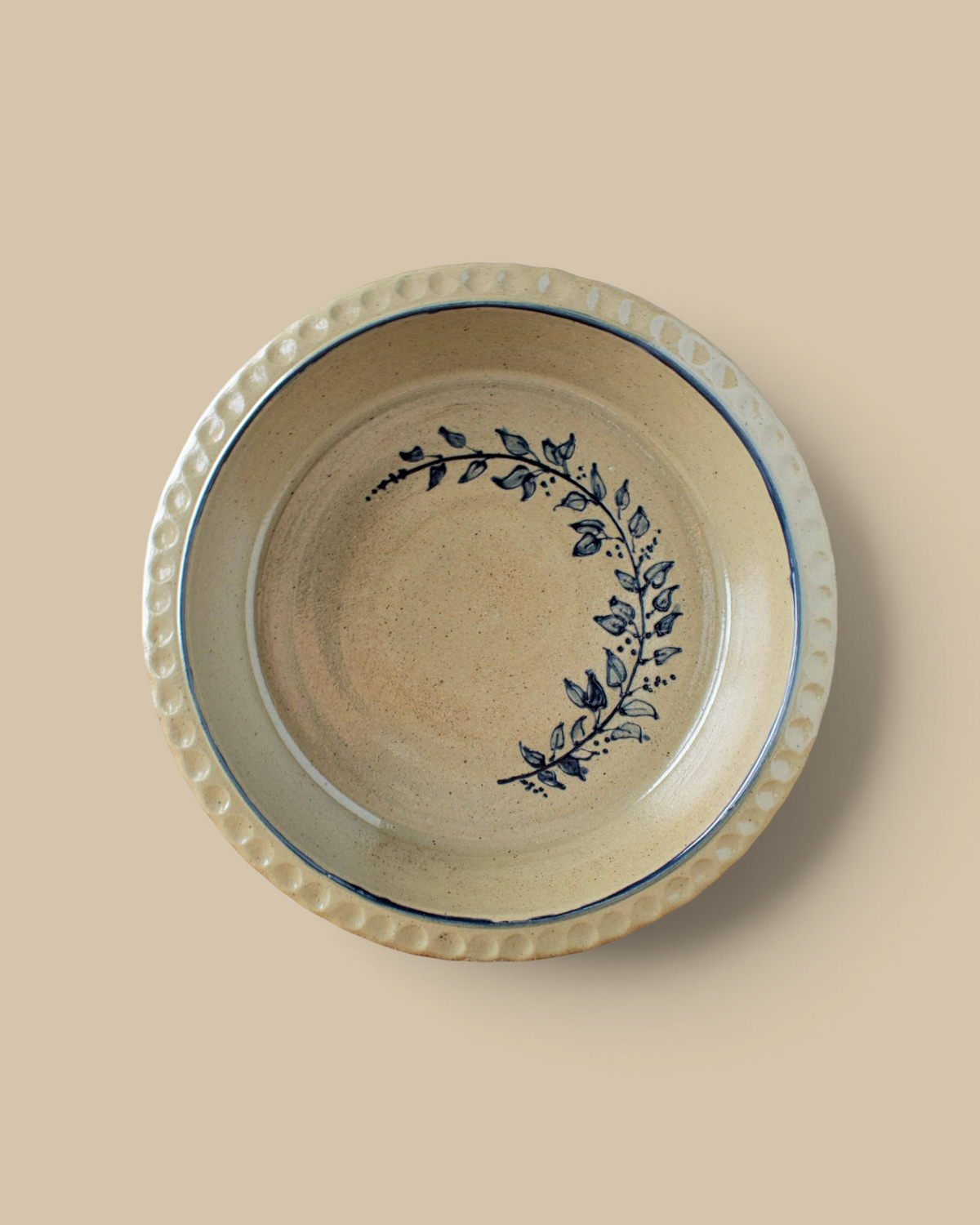 Homestyle Collective handcrafted stoneware pie plate with a deep dish design and blue floral vine pattern.
