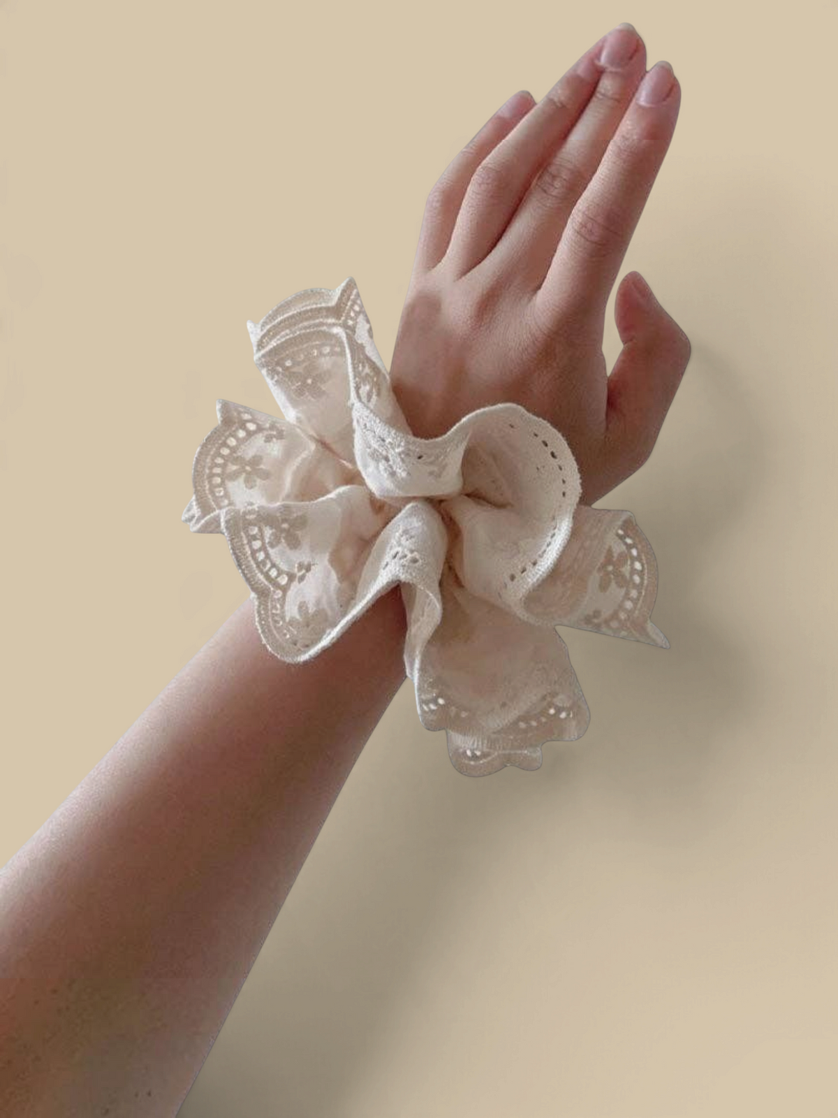 Homestyle Collective off-white double-layer hair scrunchie with vintage lace embroidery worn on a wrist