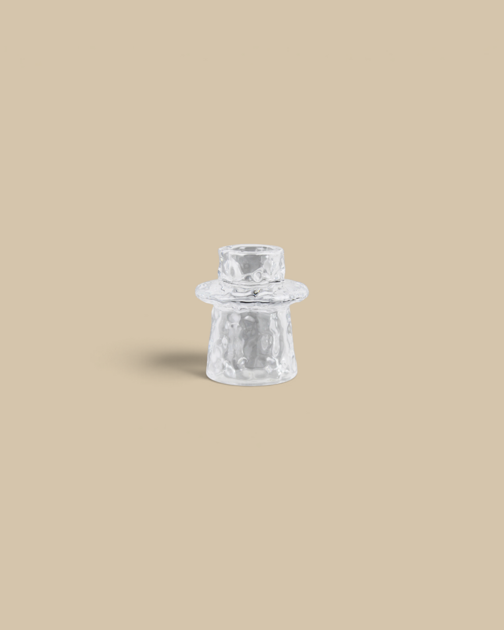 Homestyle Collective clear pressed glass taper candle holder with an organic textured surface for a shimmering glow.