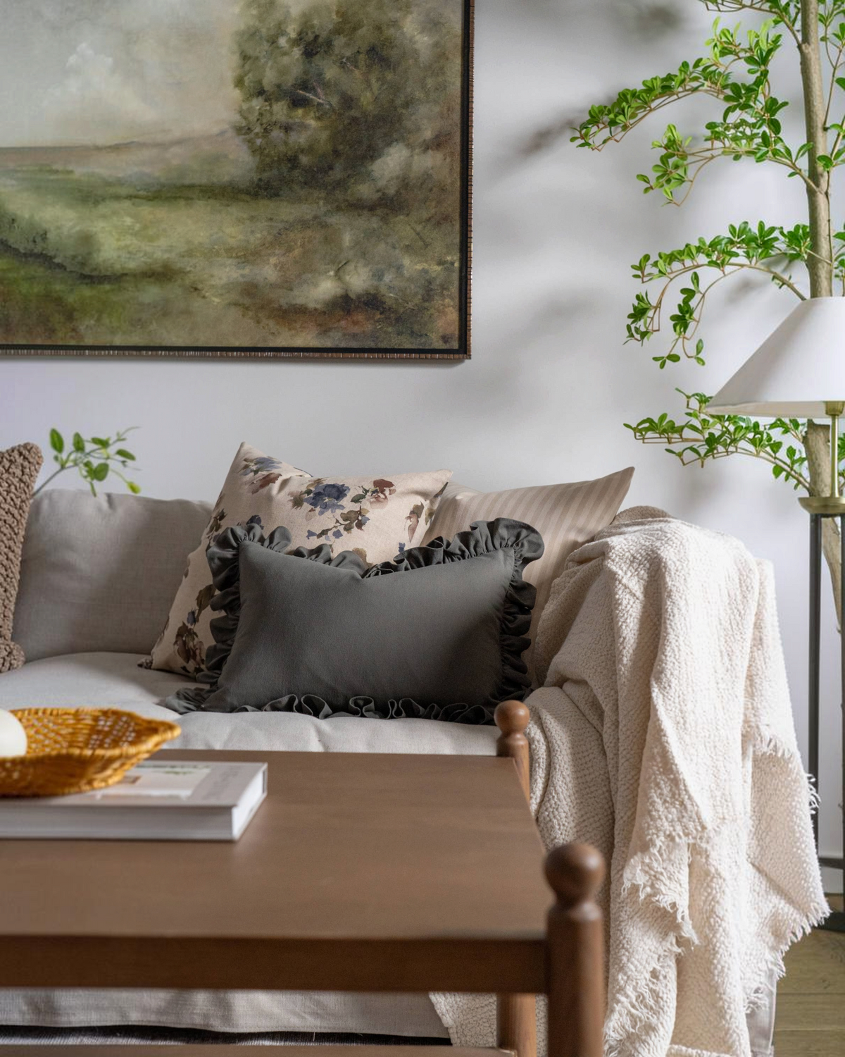 Homestyle Collective green sand-wash cotton lumbar pillow cover with decorative ruffles on a neutral sofa