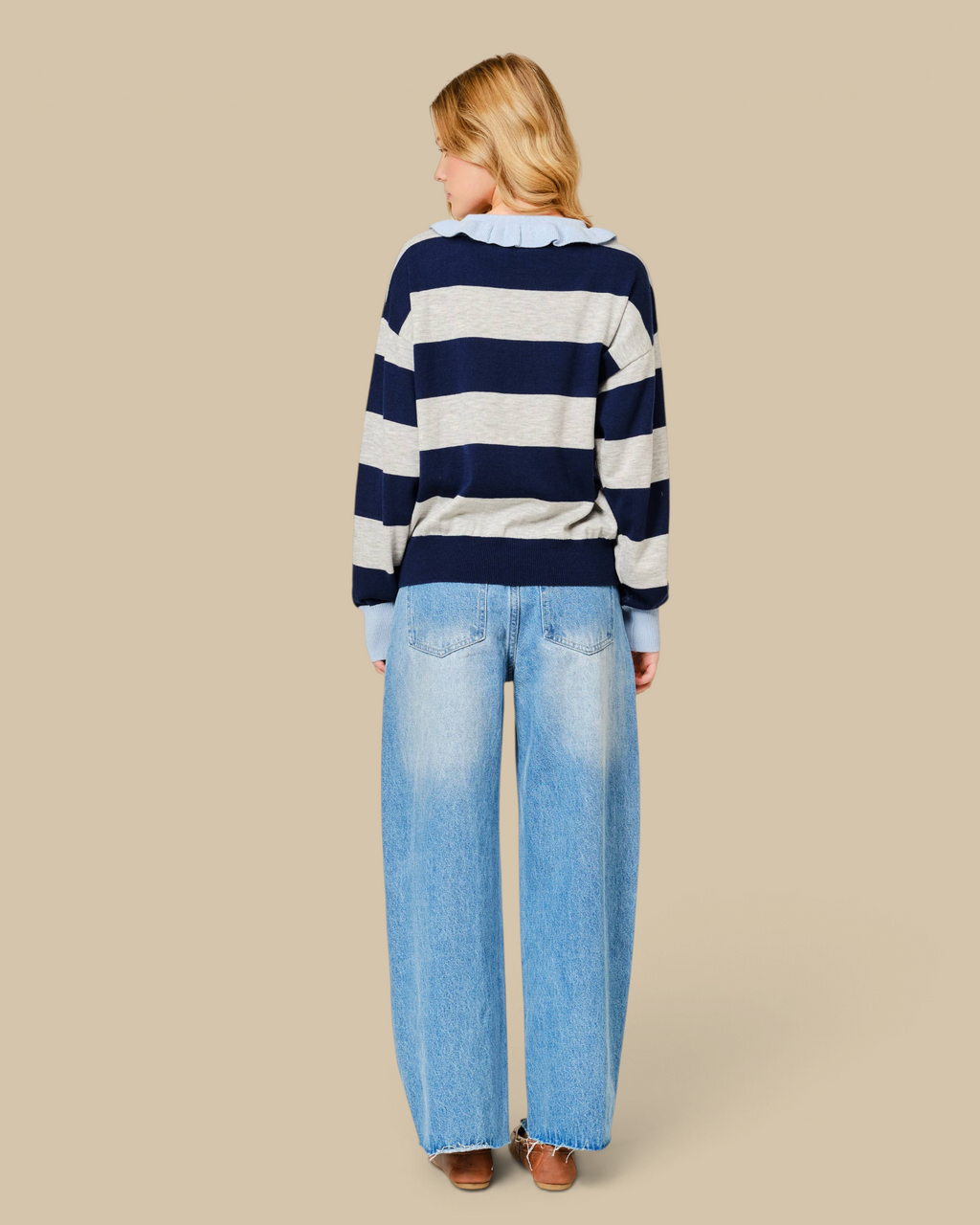 Homestyle Collective barrel leg denim jeans with lace side trim, shown from the back on a model in a striped sweater.