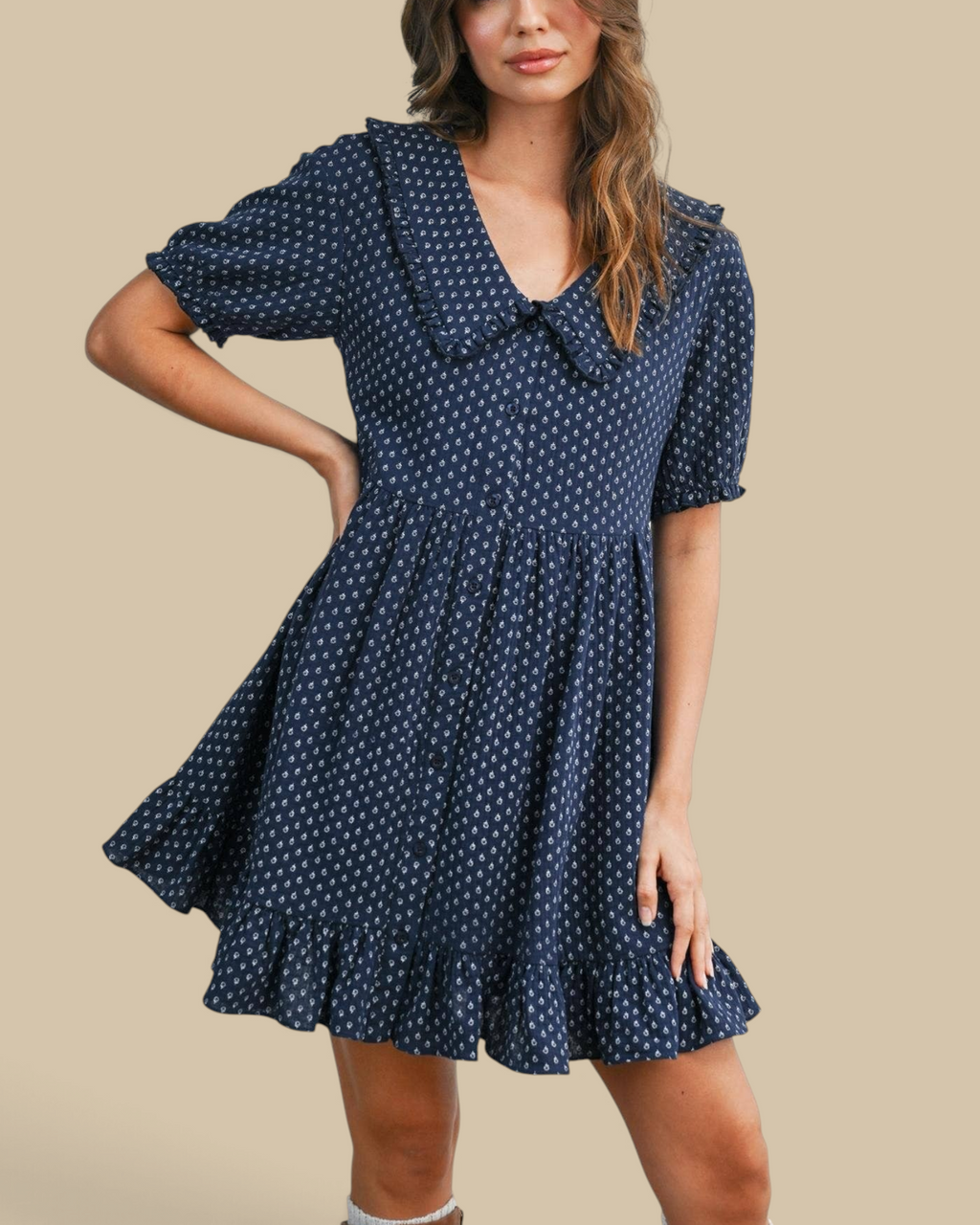 Homestyle Collective navy mini dress with puff sleeves, ruffled hem, button front, and white floral print pattern.