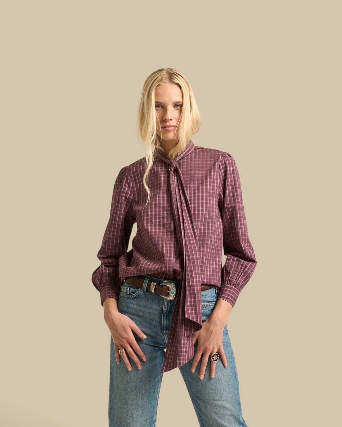 Homestyle Collective Lily Blouse in burgundy gingham cotton with a tie-neck detail and long sleeves on a model.