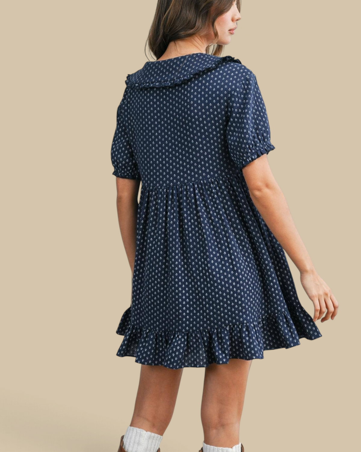 Homestyle Collective navy mini dress with puff sleeves, ruffled hem, and white print, worn with brown boots
