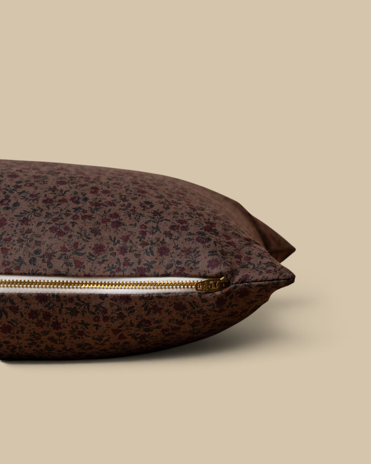 Homestyle Collective Trudie floral linen pillow cover in brown and burgundy with an exposed brass zipper detail.