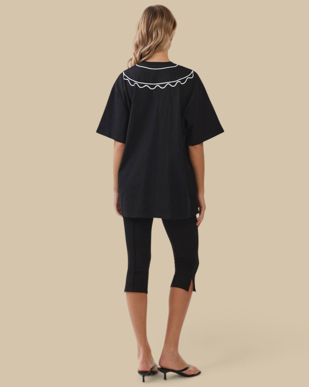 Homestyle Collective black oversized cotton tunic tee featuring a white scalloped collar, back view on a model.