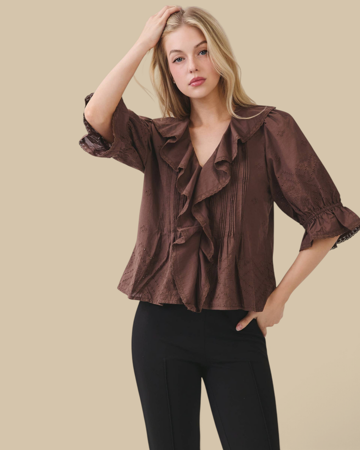 Homestyle Collective brown cotton eyelet blouse with ruffle front, pintuck pleating, and volume sleeves on a model.