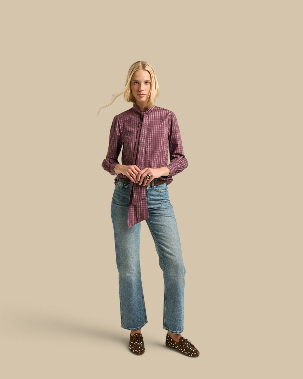 Homestyle Collective burgundy cotton gingham Lily Blouse with tie-neck detail worn with blue jeans by a blonde model.