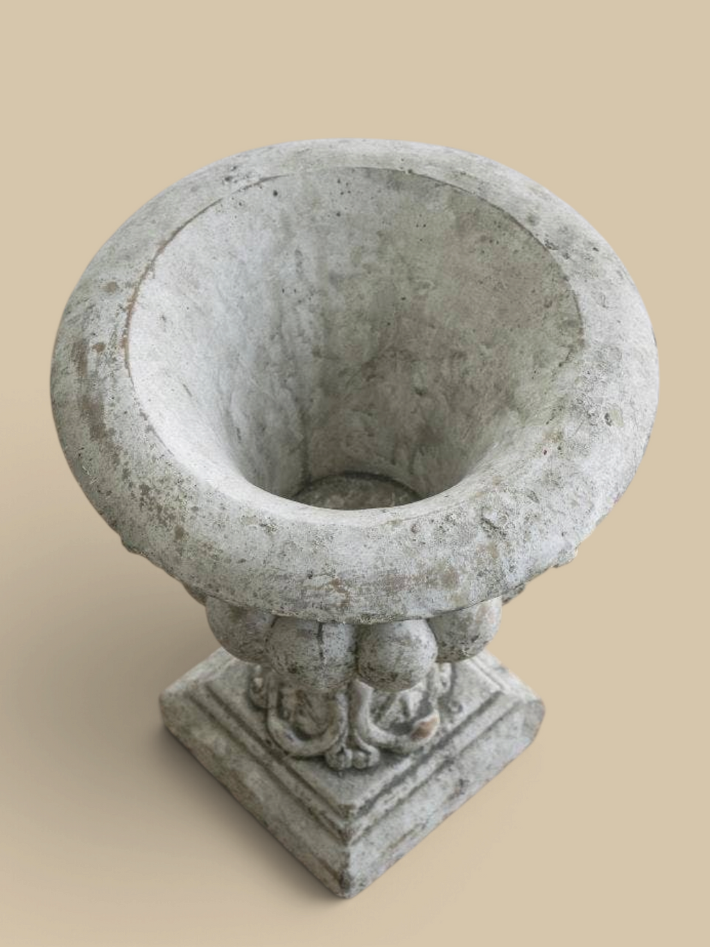 Homestyle Collective Danna garden urn in grey concrete with a classical ornate design for outdoor patio decor.