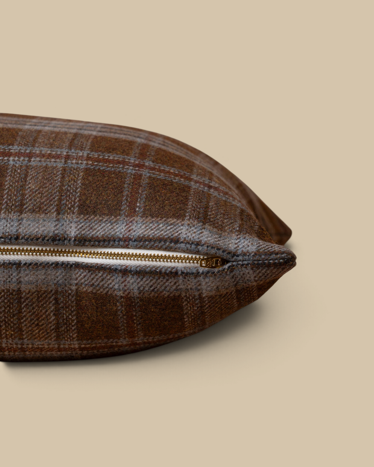 Homestyle Collective Thatcher plaid pillow cover in brown and blue wool-blend fabric with a brass YKK zipper detail.