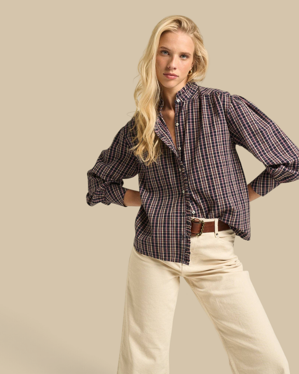 Homestyle Collective Alexa blouse in navy gingham cotton with ruffle neckline and long sleeves worn by a blonde model
