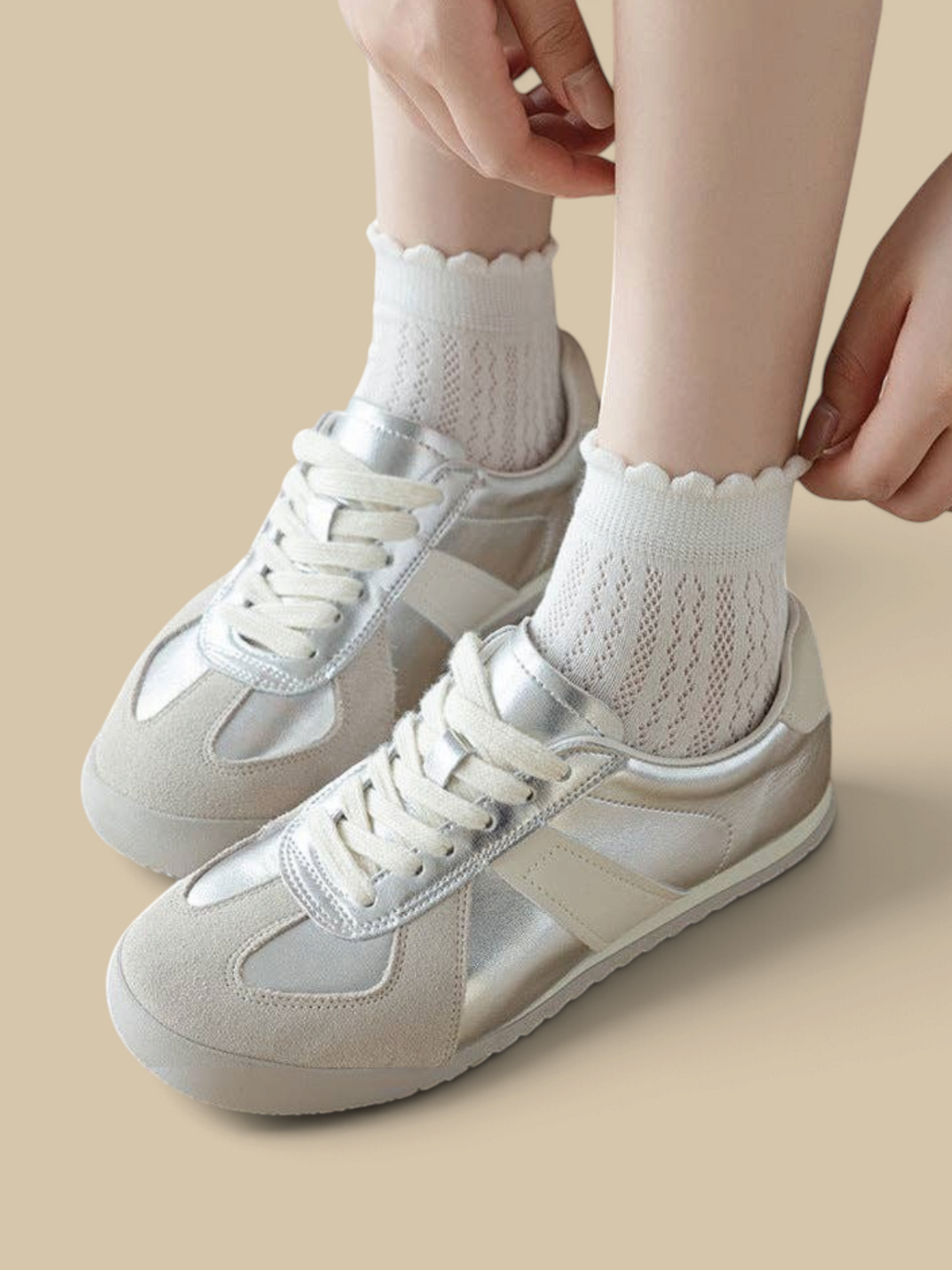 Homestyle Collective white mesh ankle socks with a delicate ruffle cuff worn with silver and beige sneakers
