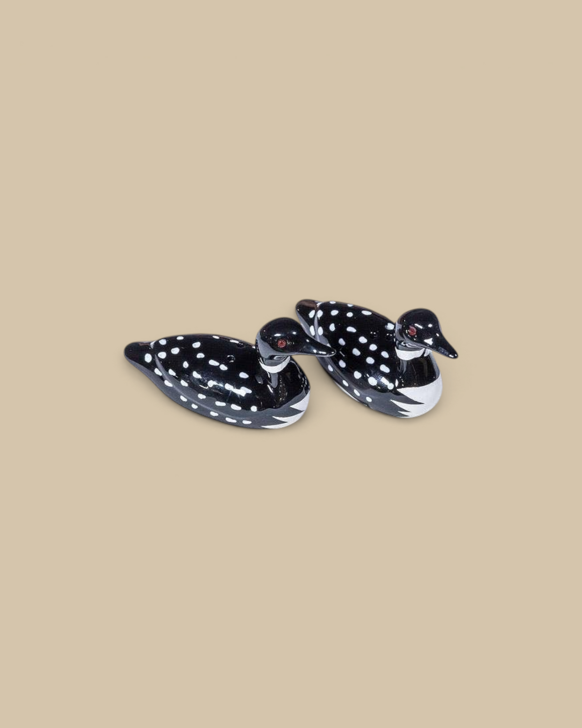 Homestyle Collective ceramic loon salt and pepper shakers with black and white spotted plumage on a white cloth