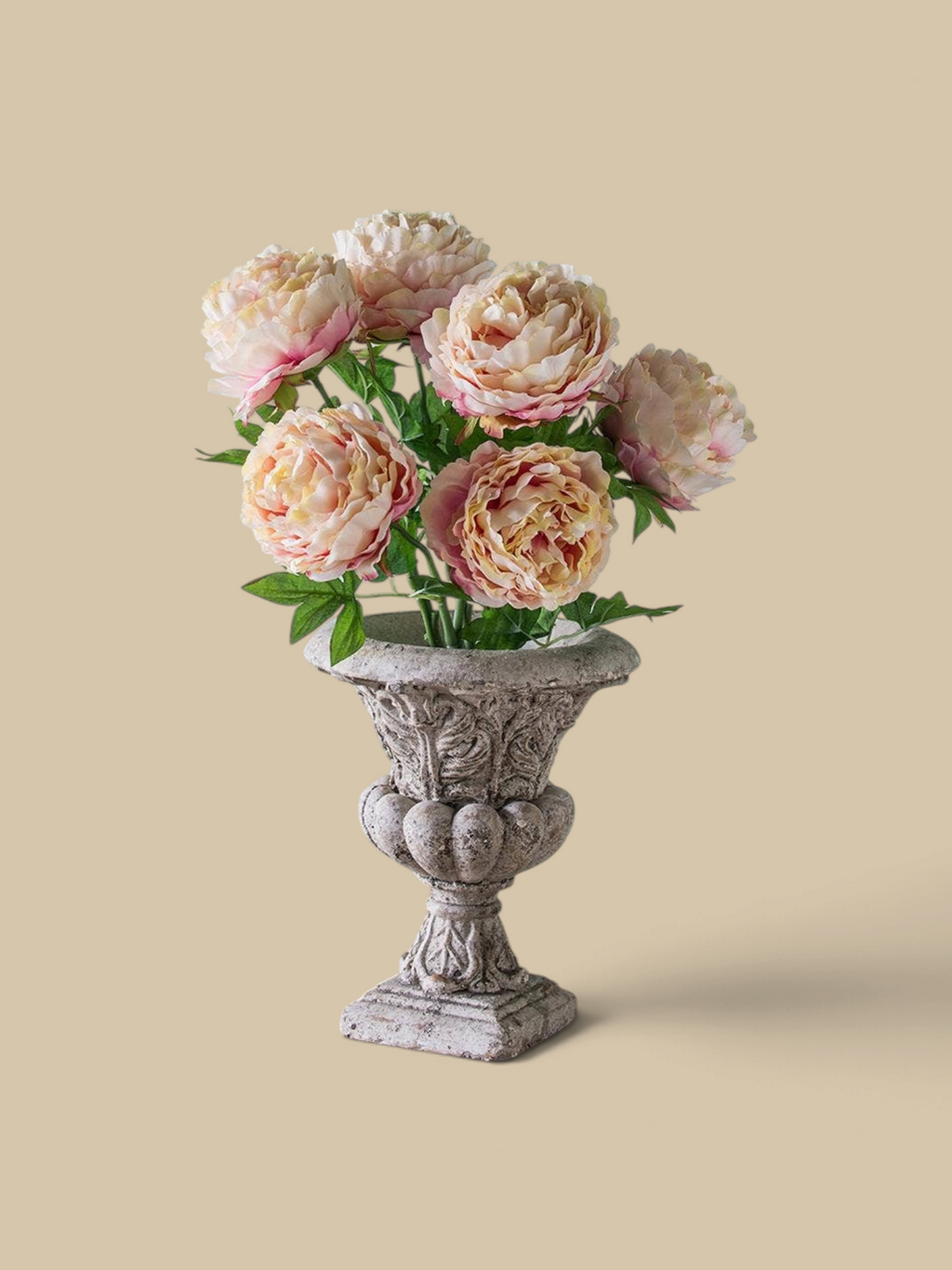 Homestyle Collective Danna Garden Urn in grey concrete with ornate classical detailing holding pink peony flowers