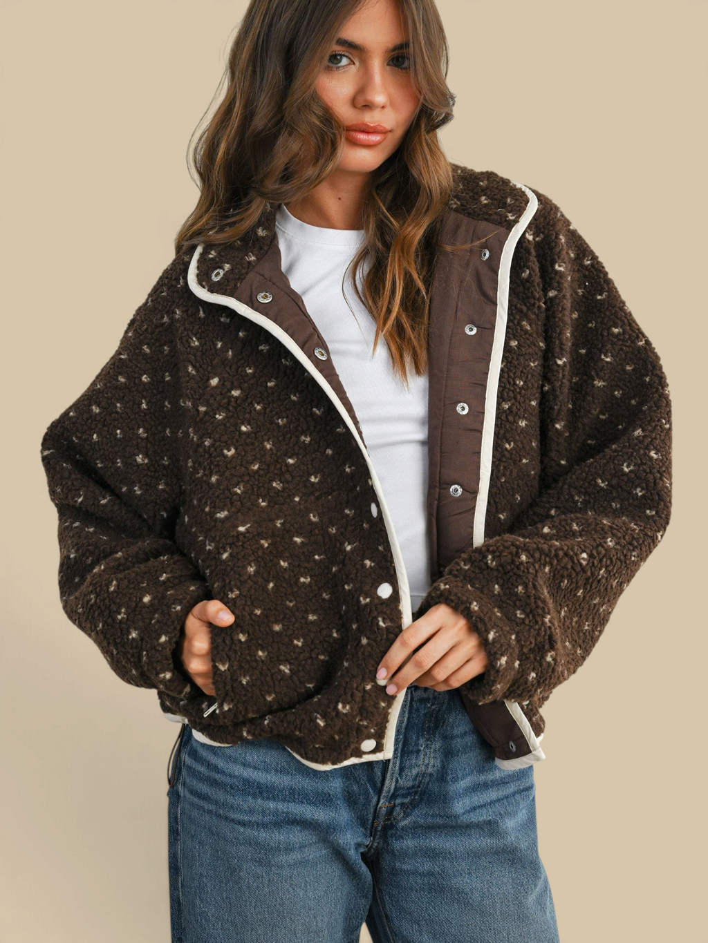 Homestyle Collective brown high pile fleece puffer jacket with white trim and snap button closure on a model