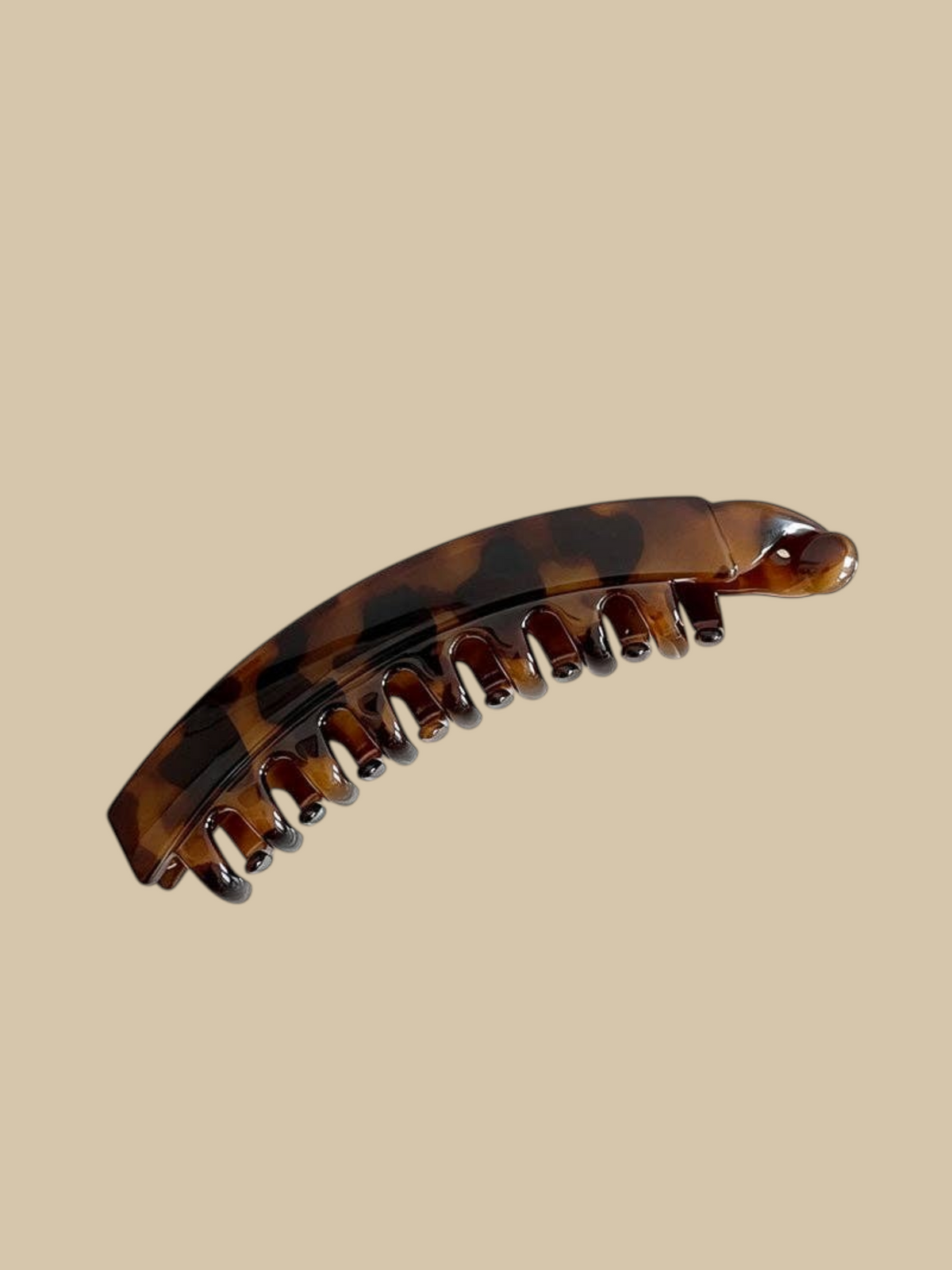 Homestyle Collective 5-inch arched banana hair claw clip in a brown leopard pattern resin with interlocking teeth.