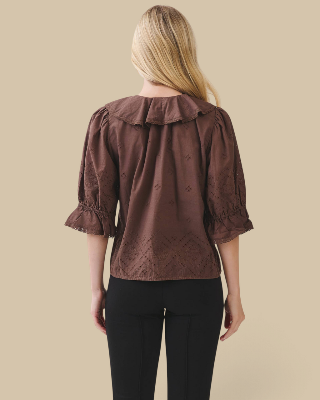 Back view of Homestyle Collective brown cotton eyelet blouse with ruffle collar and volume sleeves on a model