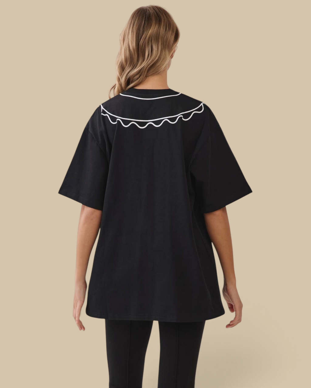 Homestyle Collective black oversized cotton tunic tee with a white scalloped collar, viewed from the back.