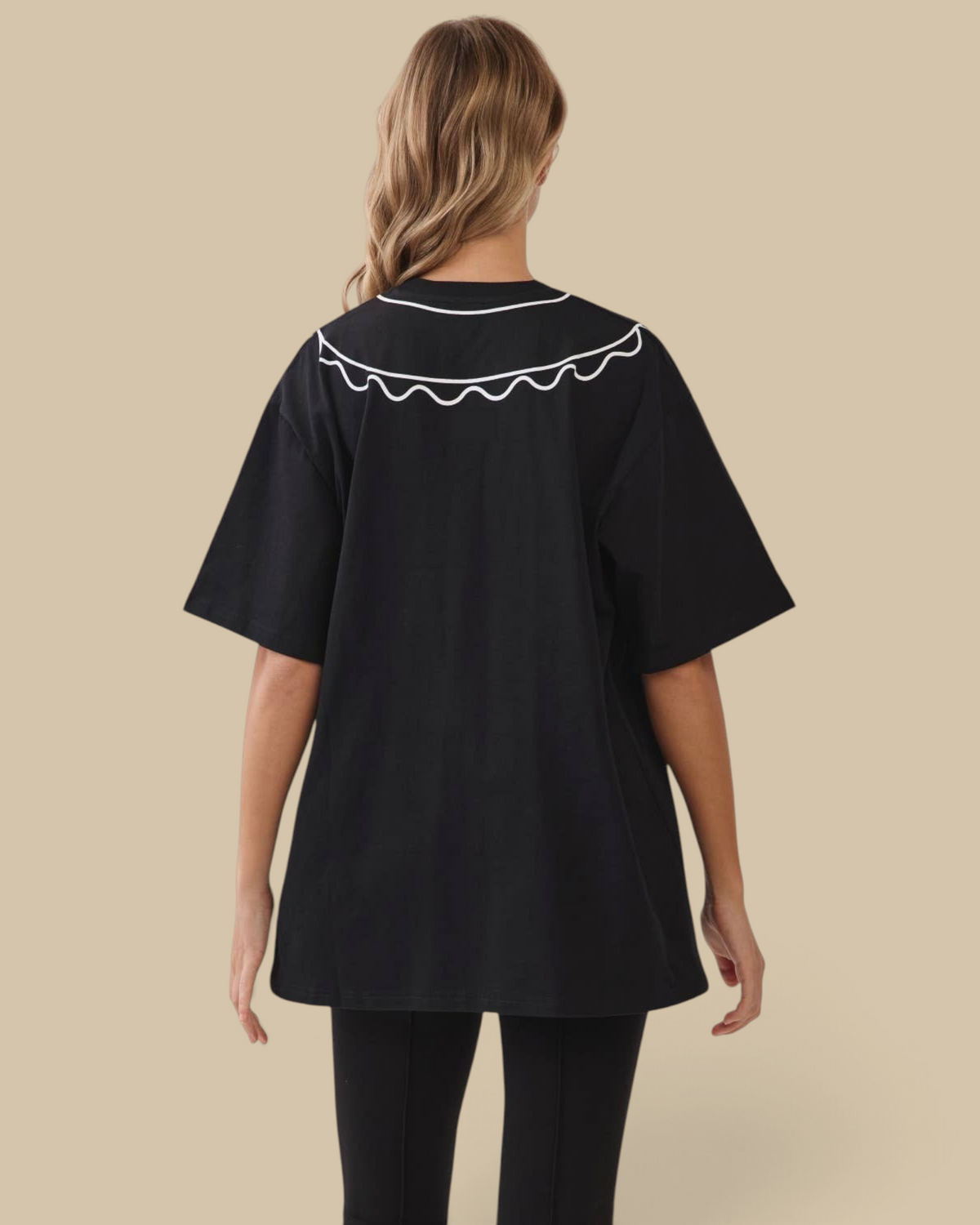 Homestyle Collective black oversized cotton tunic tee with a white scalloped collar, viewed from the back.