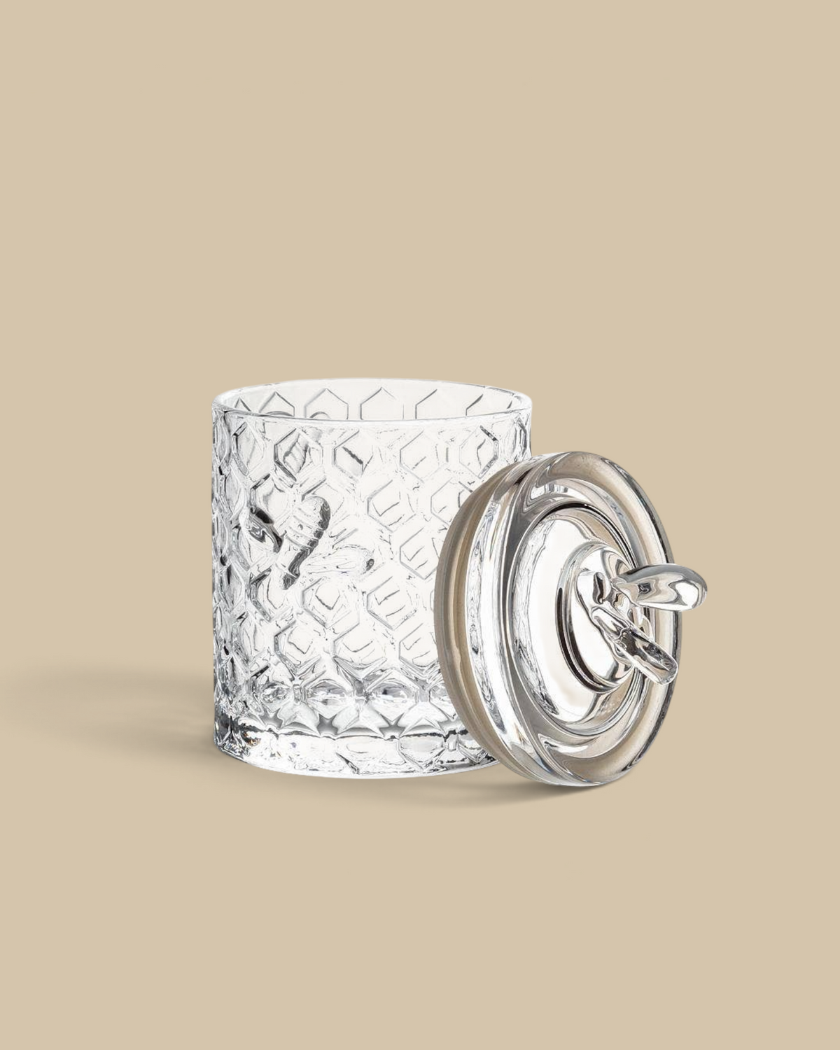 Homestyle Collective honeycomb textured glass jar with a bee-topped lid and silicone seal for kitchen storage.