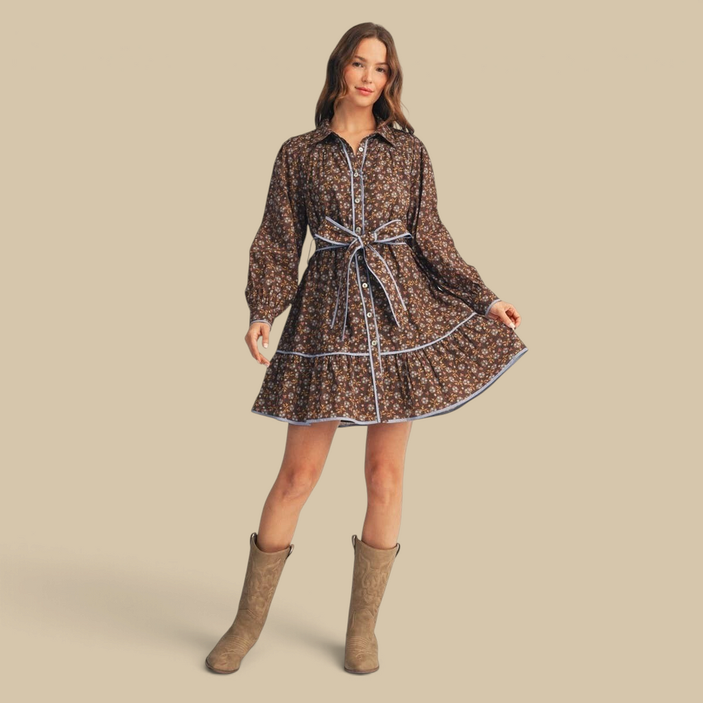 Homestyle Collective brown floral cotton dress with waist tie, button front, long sleeves, and blue contrast piping.