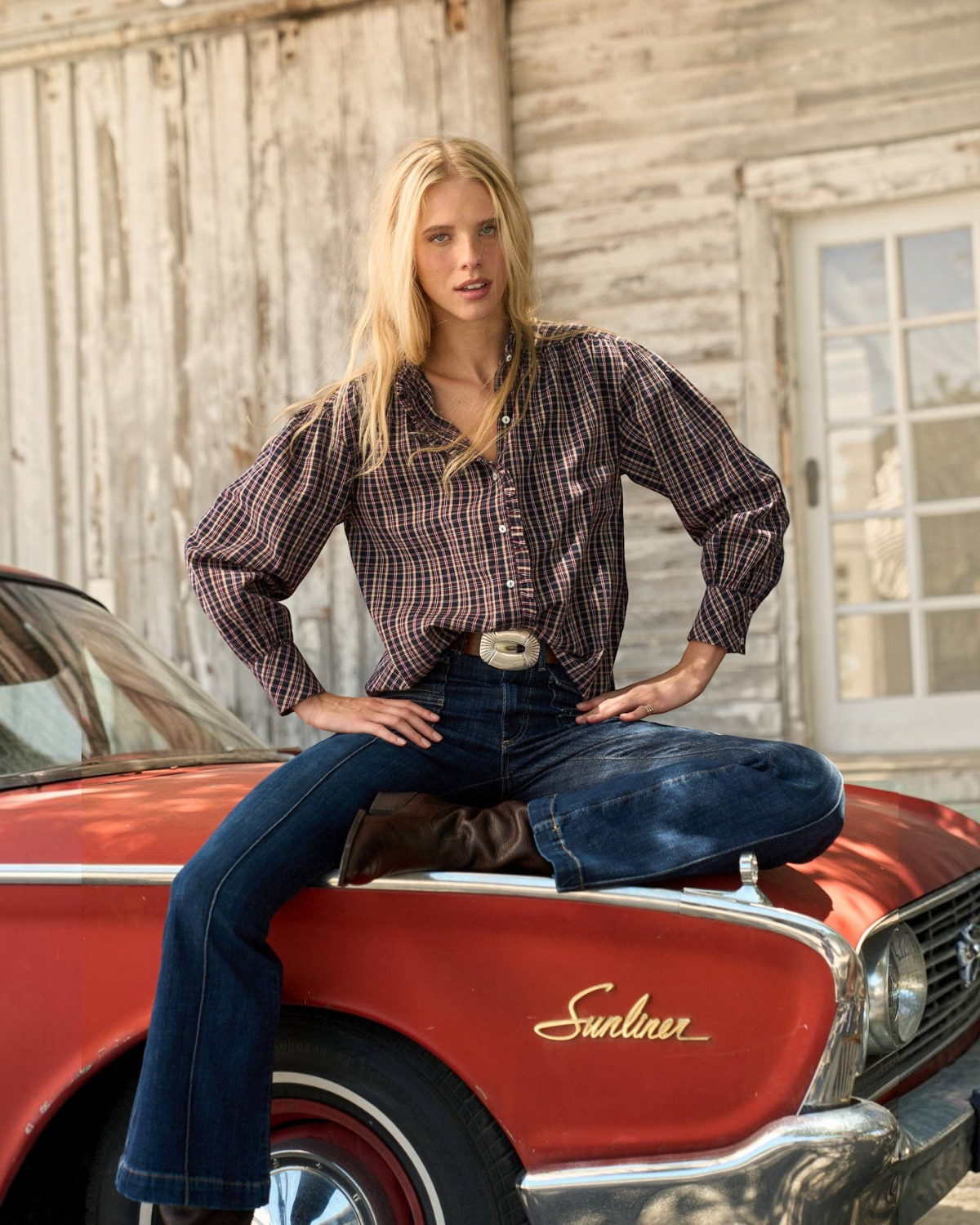 Homestyle Collective Alexa long-sleeve cotton blouse in navy gingham with ruffle neckline, worn with blue jeans.
