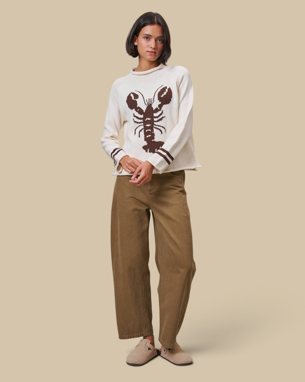 Model wearing Homestyle Collective tan cotton barrel leg pants with a high-rise waist and cropped ankle length.
